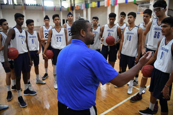 Players listen to NBA Academy India coach Ronald Cass at Jaypee Sports City on the outskirts of New Delhi