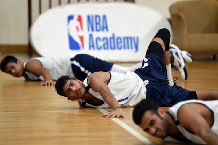 Trainees stretch during a session at the NBA Academy India