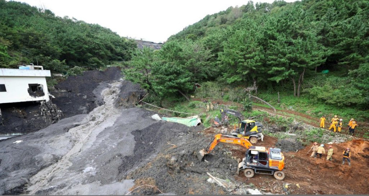 Rescue teams search for four people believed to be trapped after a landslide buried a house and restaurant in Busan