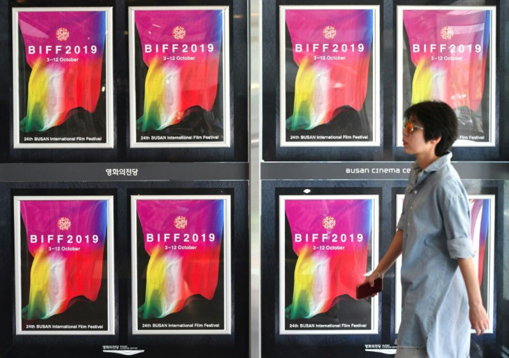 A woman walks past posters for the Busan International Film Festival at the Busan Cinema Center in South Korea