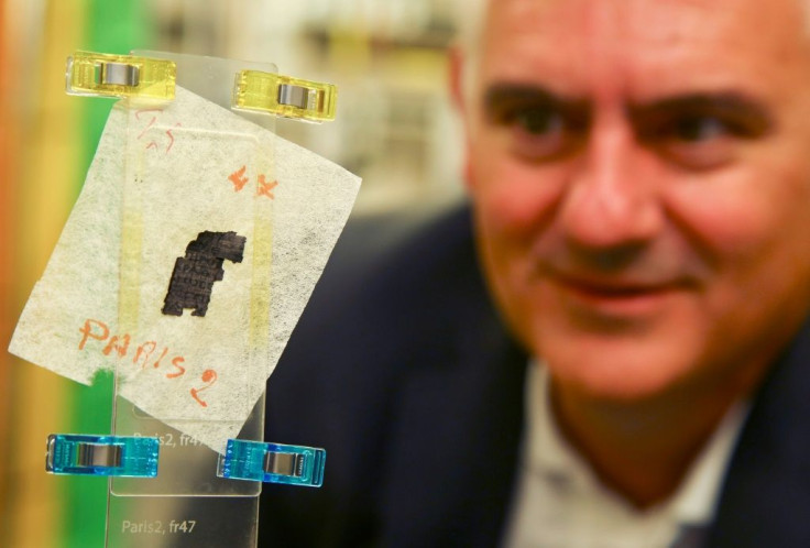 Brent Seales, director of the Digital Restoration Initiative at the University of Kentucky, examines a piece of Herculaneum scroll being deciphered with the help of a particle accelerator in England