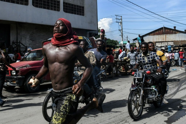 (FILES) In this file photo taken on September 23, 2019 demonstrators march on the street near parliament as they protest against ruling government in Port-au-Prince. The UN has called for calm in crisis-wracked Haiti, eight days before the end of its poli