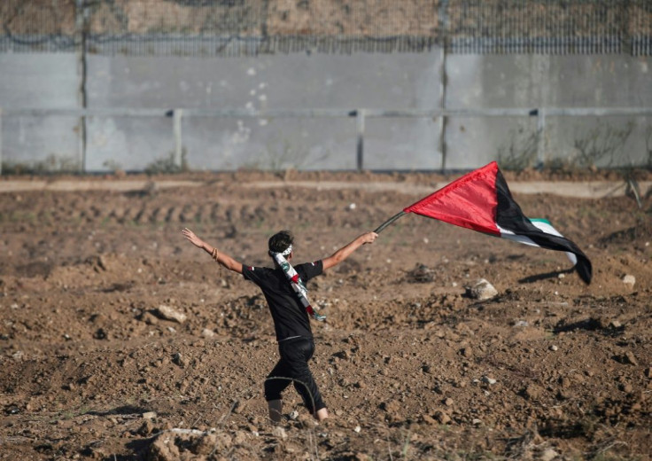 The Palestinian Authority will receive a transfer of 1.5 billion shekels ($430 million) from Israel, officials from the two governments said Friday, in a step towards resolving a months-long standoff; a young protester waves a Palestinian flag on October