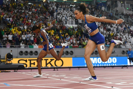 Dalilah Muhammad (left) pips Sydney McLaughlin to the line to claim gold and a new 400m hurdles world record