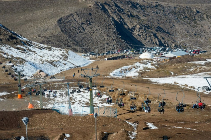 Tourists visit Farellones ski station near Santiago on August 9, which was shut down due to lack of snow