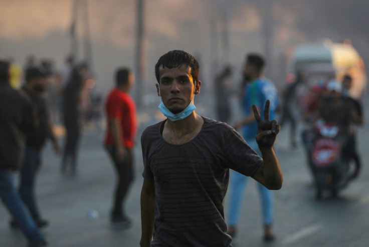 An Iraqi demonstrator flashes the victory sign during a demonstration in Baghdad Saturday