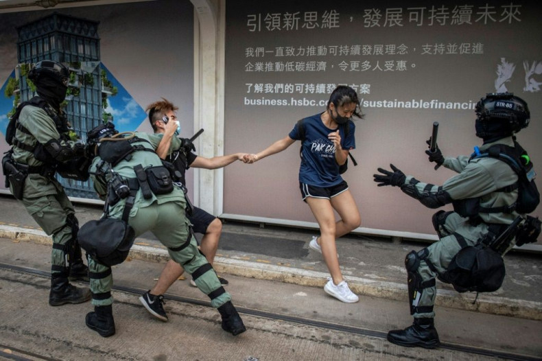 Police chased down a couple wearing facemasks in the Central district in Hong Kong