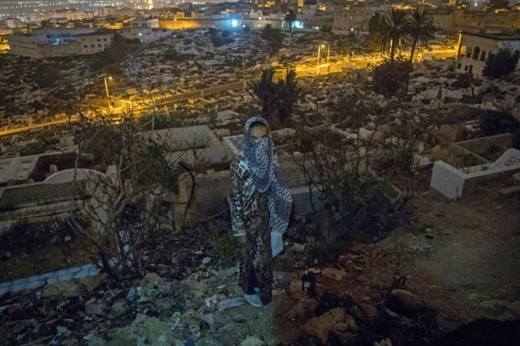 A Moroccan addict stands in a cemetery overlooking Tetouan, a common spot for drug users