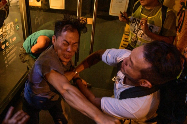 Two men fight during a clash between Beijing supporters and anti-government protesters in Hong Kong's North Point district