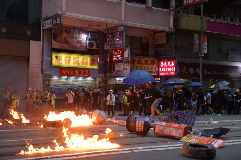 Protesters set fires and battled police Sunday, plunging the finance hub into chaos once more
