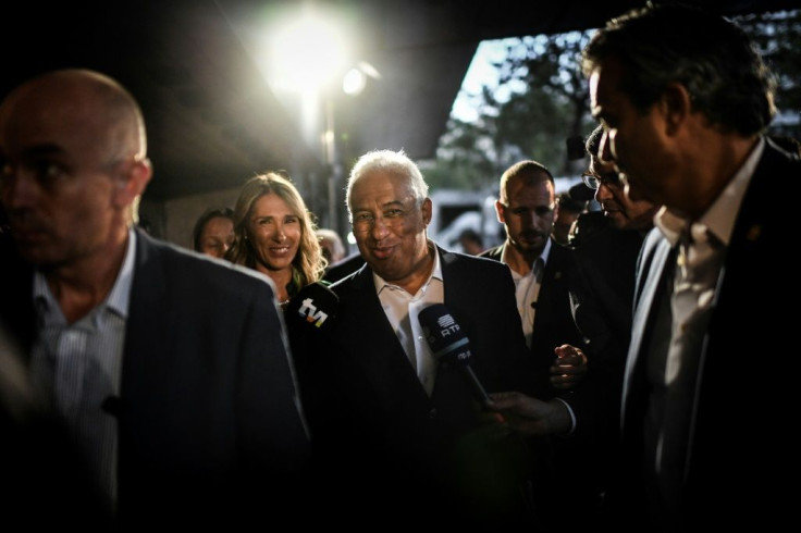Socialist Prime Minister Antonio Costa (C) arrives at a party gathering in Lisbon as exit polls show the Socialists have taken the lead in Sunday's election