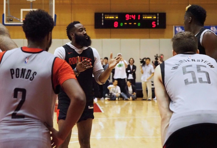 Houston Rockets star James Harden (2nd L) instructs his teammates during a training session in Tokyo