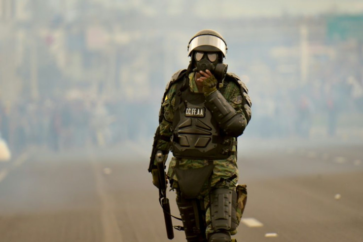 A soldier takes up position during clashes with indigenous people and farmers protesting against fuel hikes introduced by Ecuador's President Lenin Moreno, on the outskirts of Quito