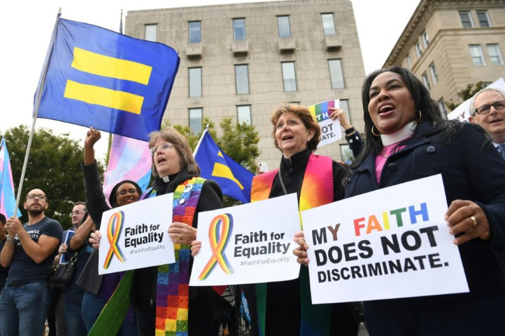 Demonstrators in favor of LGBT rights rally outside the US Supreme Court in Washington ahead of the court's hearing on gay and transgender workplace rights