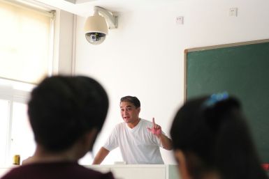 Ilham Tohti, a Uighur scholar imprisoned in China whom the European Parliament has put on its shortlist for the Sakharov Prize, lectures in a classroom in Beijing in 2010