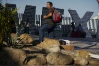 A migrant from Honduras waits at the Mexico-United States border crossing in Tijuana, Mexico on September 12