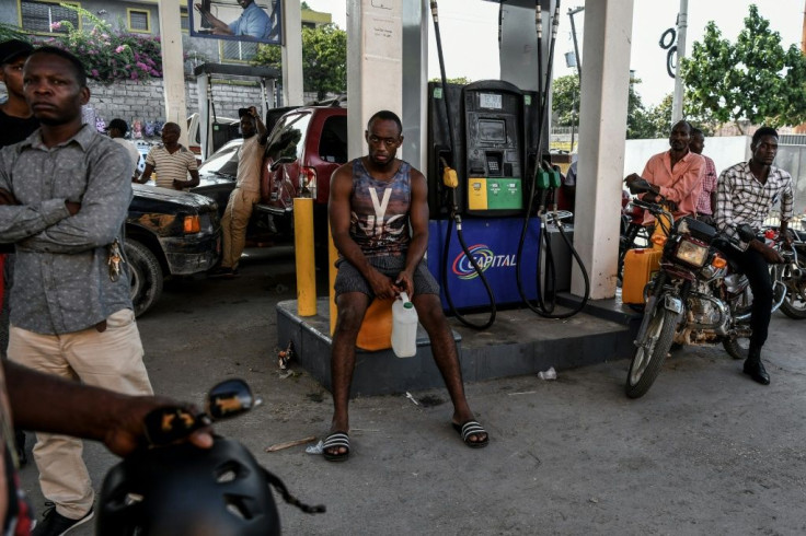 People wait for fuel at a gas station in Port-au-Prince, on August 29, 2019 -- the fuel shortage sparked increased anger and sporadic violence