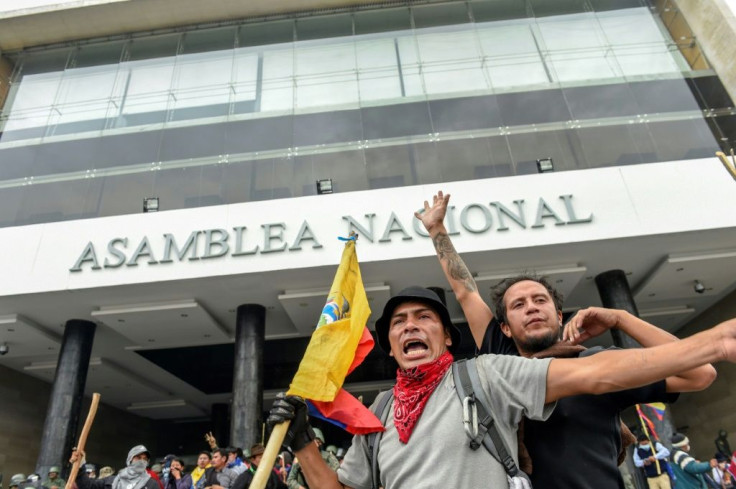 Demonstrators outside the national assembly in Quito during clashes with riot police