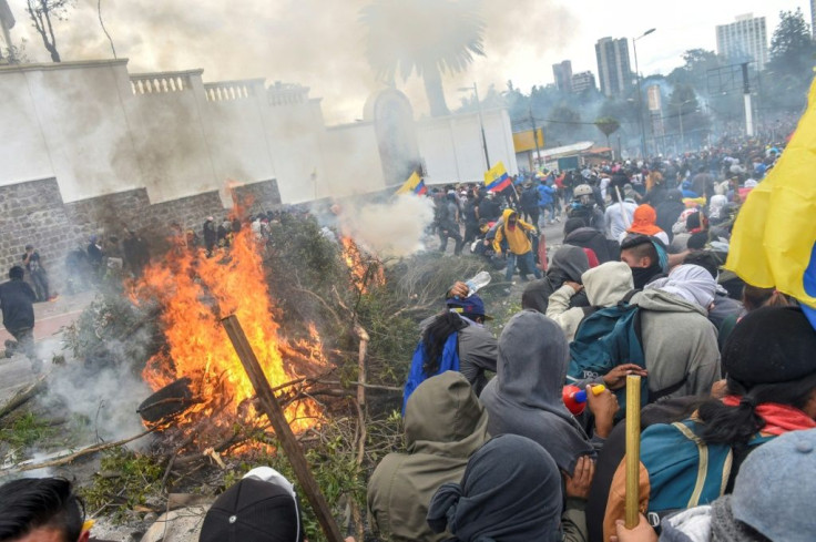 Demonstrators burn branches and tyres outside the national assembly in Quito during clashes with security forces on October 8, 2019