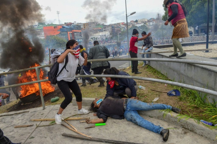 A protester lies on the ground as demonstrators are dispersed away from the national assembly by riot police