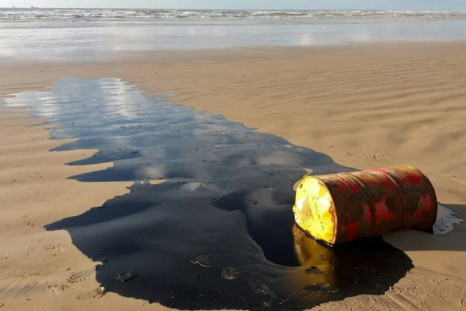 A barrel of oil leaking on a beach in Barra dos Coqueiros, in the Braziilian state of Sergipe