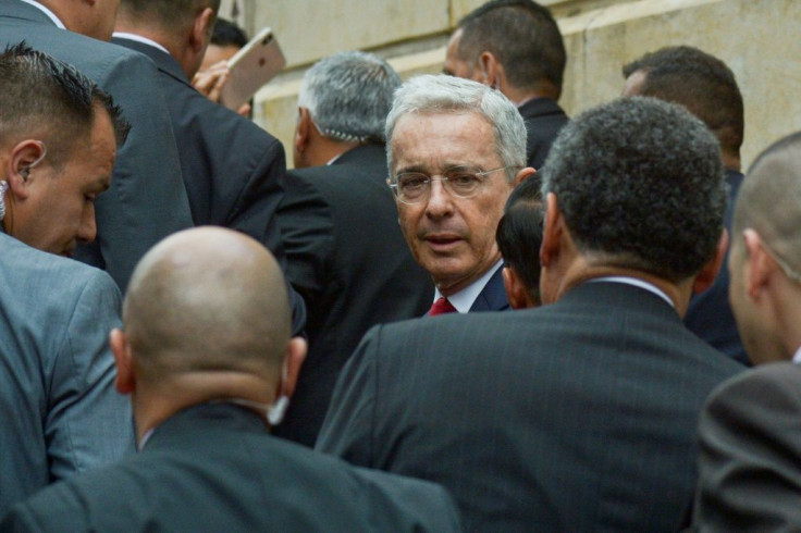 Former Colombian president Alvaro Uribe (C) arrives at the Palace of Justice for a hearing before the Supreme Court in a case over witness tampering