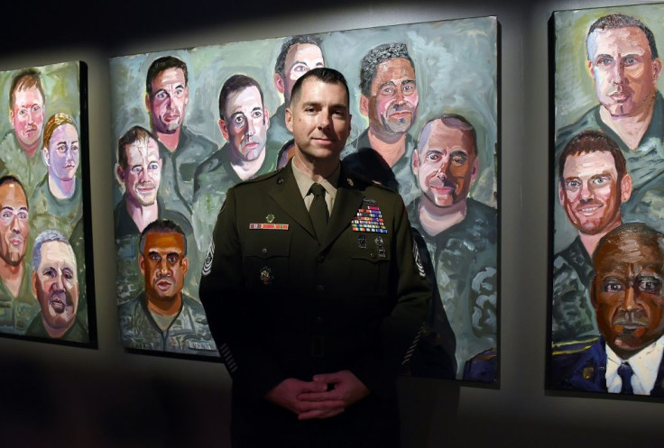 Command Sergeant Major Brian Flom, pictured next to a painting of himself by former president George W. Bush, was wounded in the face by a rocket attack in Iraq in 2007