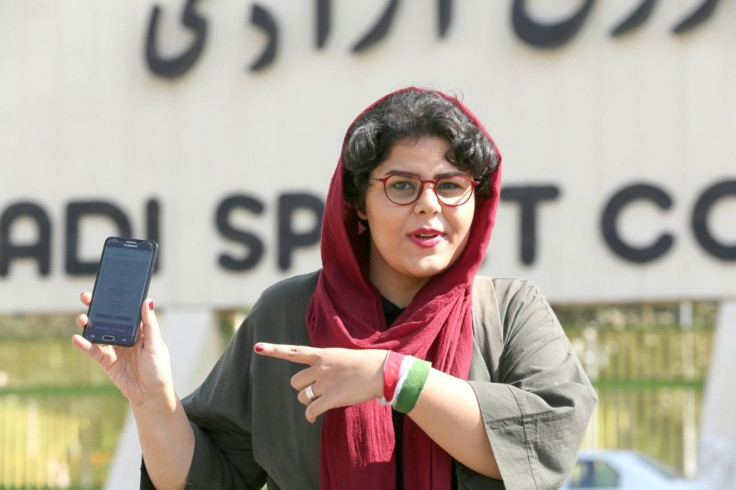 Iranian sports journalist Raha Pourbakhsh shows purchased electronic tickets for the Iran-Cambodia World Cup 2022 match in front of Azadi stadium in the capital Tehran