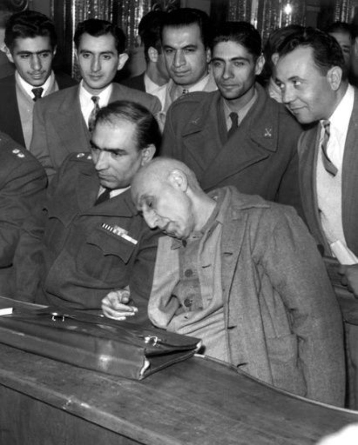 Ex-Iran prime minister Mohammad Mossadegh (R) rested his head on his lawyer's shoulder during his trial in a military court in 1953
