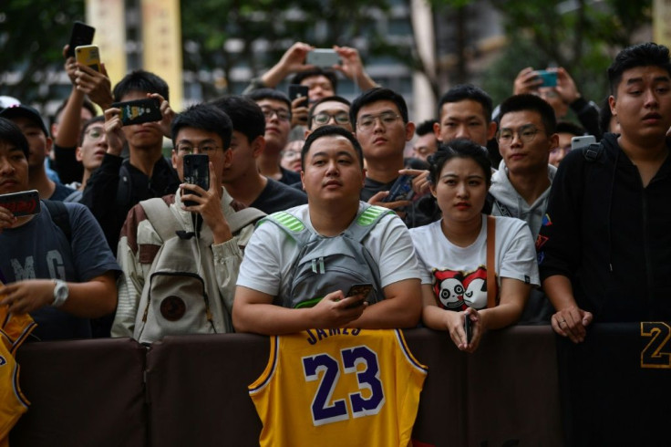 Fans in Shanghai wait outside a hotel for National Basketball Association (NBA) players ahead of a scheduled preseason game in China, where the NBA has built a lucrative fanbase