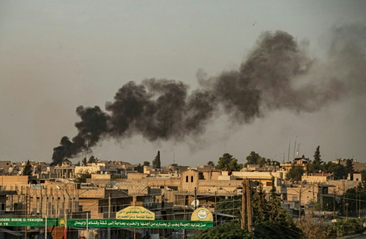 Smoke billows into the air following Turkish bombardment on Syria's northeastern Kurdish-held town of Ras al-Ain on October 9, 2019