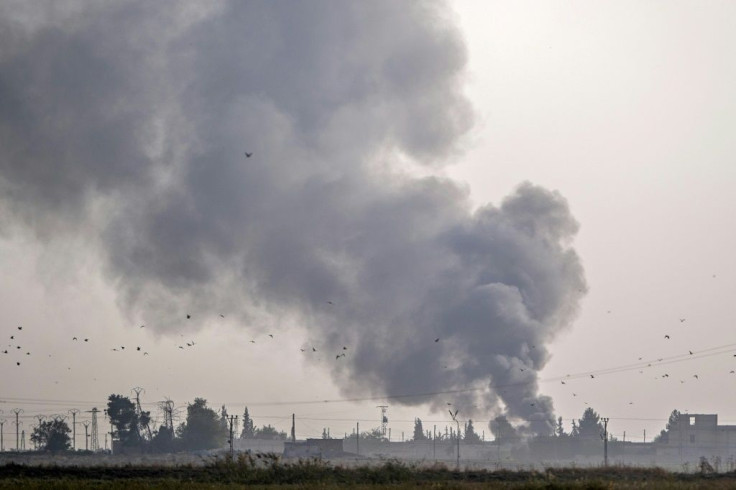 Smoke rises from the Syrian town of Tal Abyad after Turkish bombings Wednesday as Ankara opened up an assault on the mostly Kurdish region