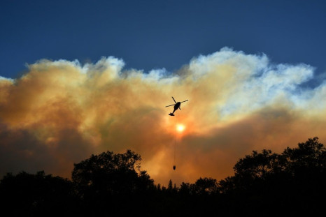 On November 11, 2018 a helicopter makes a water drop on the wildfires in the Feather River Canyon, east of Paradise, California