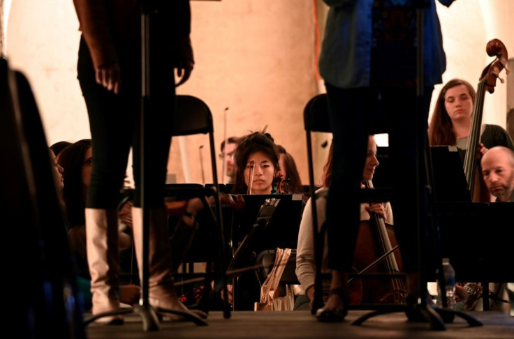 Musicians rehearse a string concerto performance being held in the catacombs of the Green-Wood Cemetery in New York's Brooklyn borough