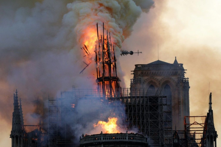 The steeple and spire collapses as smoke and flames engulf the Notre-Dame cathedral