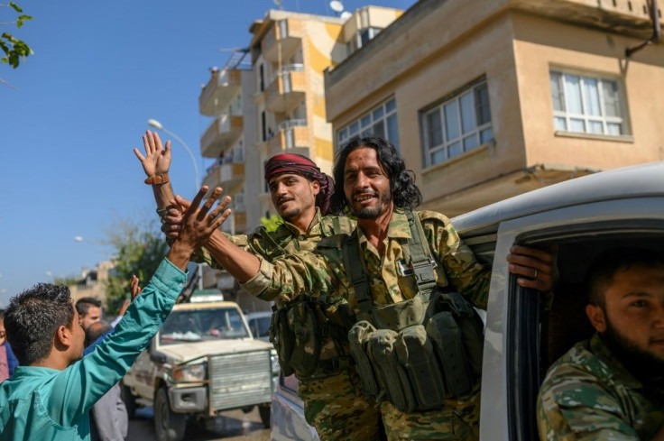 Dozens of vehicles carrying former Syrian rebels allied with Ankara have crossed the border into Syria to cheers from Turkish onlookers