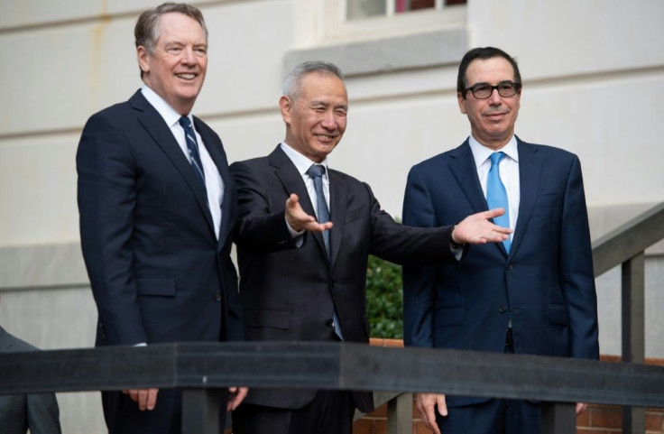 Chinese Vice Premier Liu He is greeted Thursday by US Trade Representative Robert Lighthizer (L) and Treasury Secretary Steven Mnuchin (R)