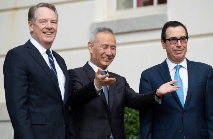 Chinese trade envoy Liu He is greeted Thursday by US Trade Representative Robert Lighthizer (L) and Treasury Secretary Steven Mnuchin (R)