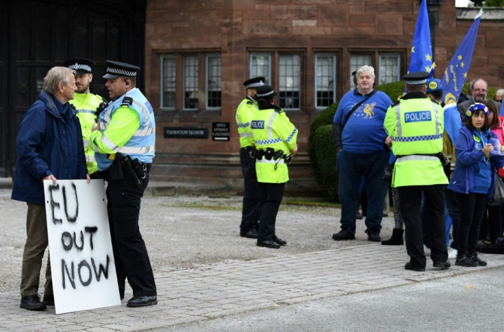A pro-Brexit demonstrator (L) and a group of anti-Brexit protestors gathered outside the meeting at Thornton Manor