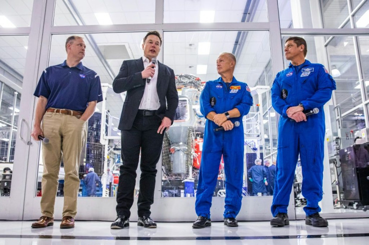 (L-R) NASA Administrator Jim Bridenstine, SpaceX founder Elon Musk, and astronauts Doug Hurley and Bob Behnken speaking during a news conference at SpaceX headquarters in Hawthorne, California on October 10, 2019