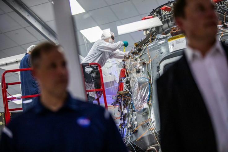 Employees of SpaceX work on the Crew Dragon reusable spacecraft during a press conference at SpaceX headquarters in Hawthorne, California on October 10, 2019