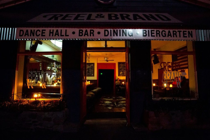 Patrons sit at candle-lit tables at a restaurant in Sonoma, California, on October 9 during a planned power outage