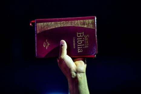 A believer holds up a King James version of the Bible during a religious service in San Martin, Buenos Aires province