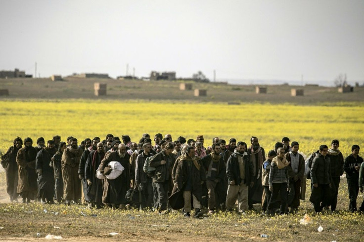 Men suspected of being Islamic State fighters surrender to Kurdish Syrian Democratic Forces in March 2019