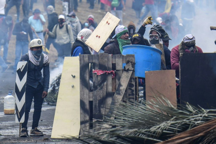 Demonstrators in Ecuador clash with riot police during a protest over a fuel price hike ordered by the government to secure an IMF loan