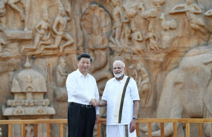 Indian Prime Minister Narendra Modi (R) shakes hands with Chinese President Xi Jinping ahead of their informal summit, but their two countries have never been the best of friends