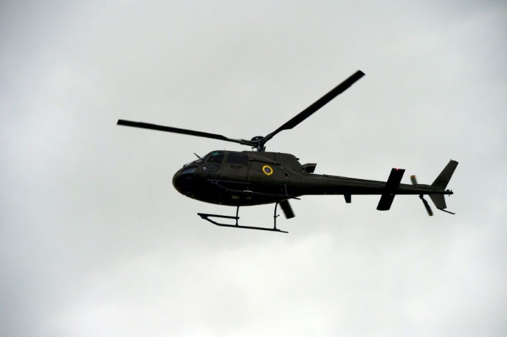 A military helicopter overflies a protest in Quito