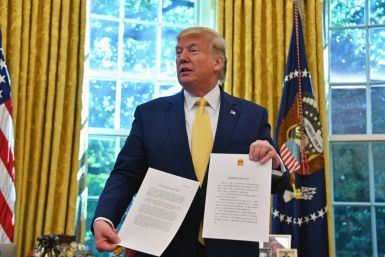 US President Donald Trump shows a letter from Chinese President Xi Jinping as he announces and initial deal with China while meeting the special Envoy and Vice Premier of the People's Republic of China Liu He Special Envoy and Vice Premier of the People's