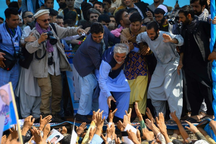 Afghan presidential candidate Abdullah Abdullah (C) claimed victory just two days after the September 28 election and before all votes had even arrived in Kabul for counting