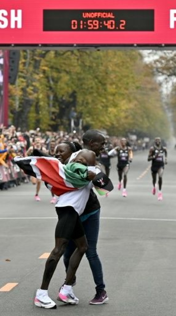 Kipchoge celebrates with his wife Grace